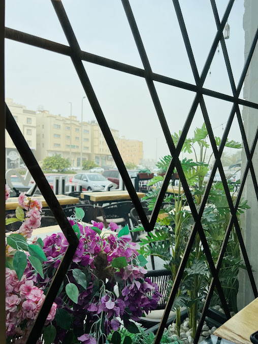 Welcoming view through Khan Al-Rayhan's geometric window to the outdoor seating