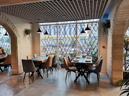 Khan Al-Rayhan dining room with stone arches and geometric windows